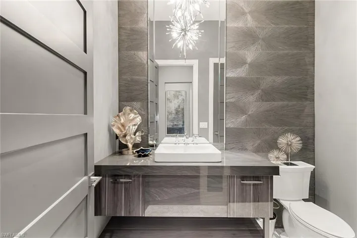 Bathroom with vanity and tile walls