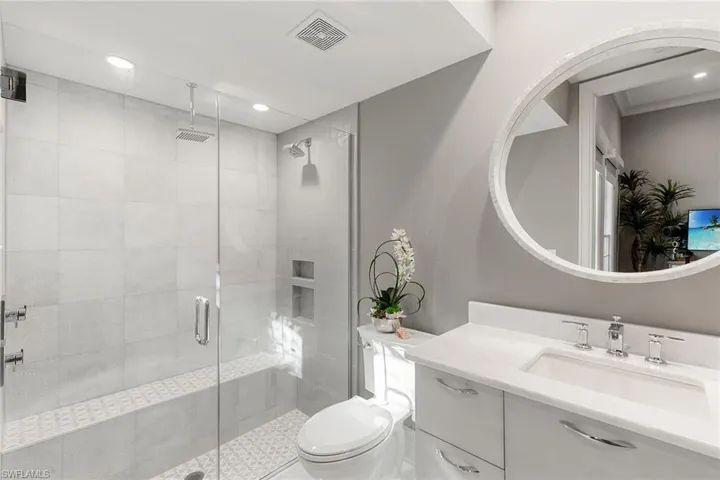 Bathroom featuring vanity, a shower stall, and recessed lighting