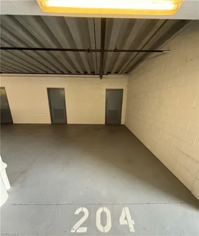 Garage featuring concrete block wall