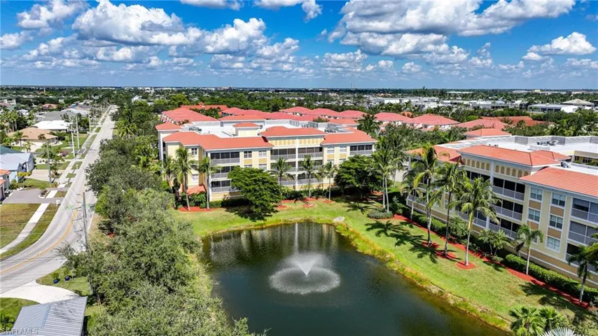 Drone / aerial view of apartment complex and a large body of water