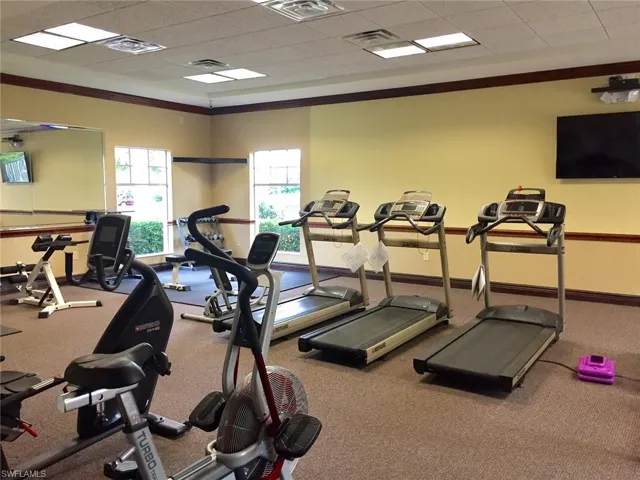 Gym with a drop ceiling and ornamental molding