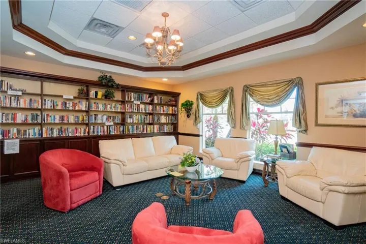 Sitting room featuring a chandelier, crown molding, a drop ceiling, and recessed lighting
