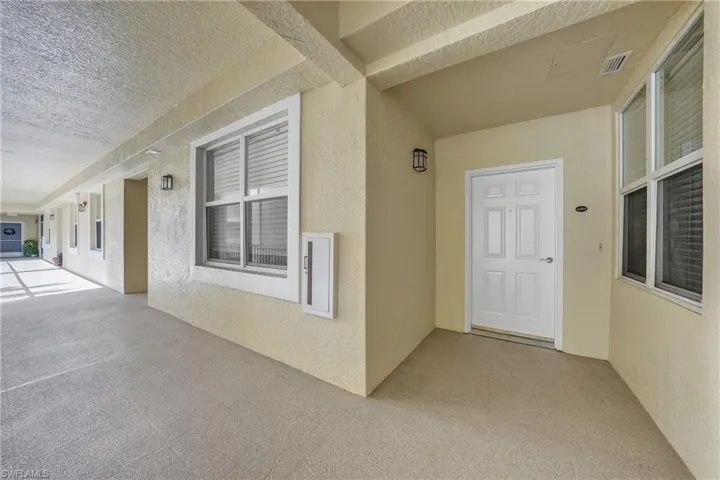Doorway to property with stucco siding