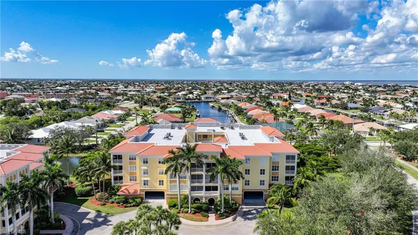 Drone / aerial view of a nearby body of water and apartment complex