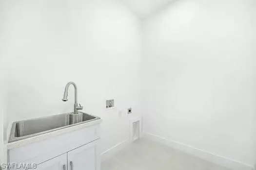 Laundry area featuring hookup for an electric dryer, washer hookup, and concrete flooring