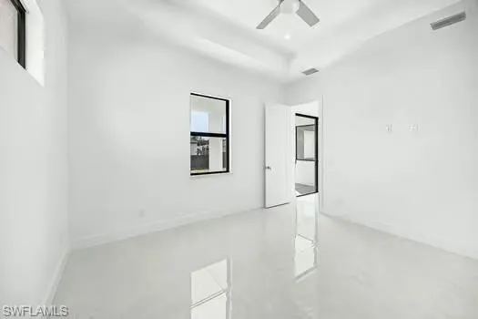 Unfurnished room with concrete floors and a ceiling fan