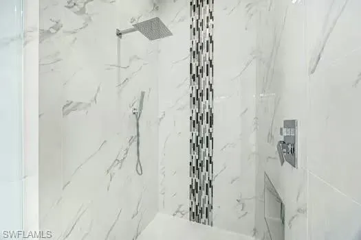 Bathroom featuring a marble finish shower