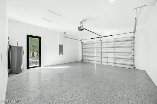 Garage featuring water heater and electric panel