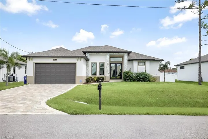 Front of structure featuring stucco finish, french doors, pavered driveway, and shingled roof