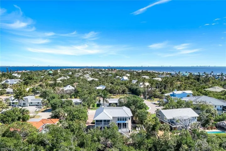 Aerial perspective of suburban area featuring a large body of water