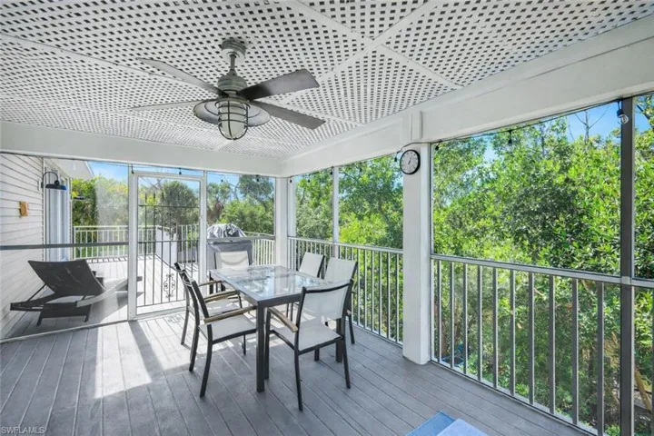 Sunroom featuring a ceiling fan and outdoor dining area