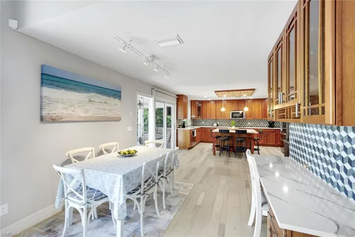 Dining room featuring light wood-type flooring and rail lighting
