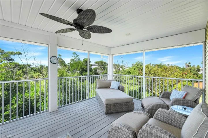 Sunroom / solarium featuring a ceiling fan and an outdoor living space