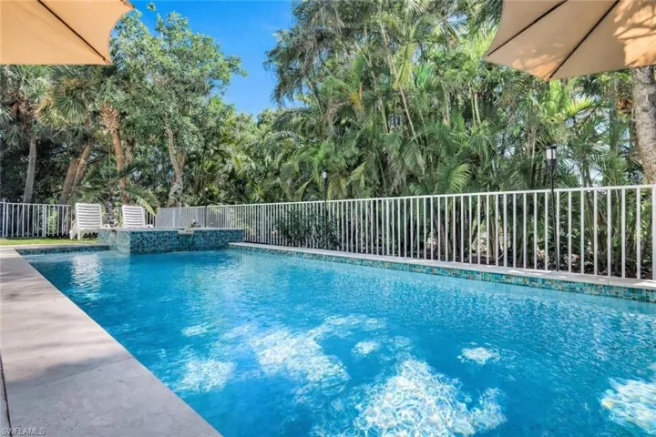 View of swimming pool featuring a fenced backyard and patio surround