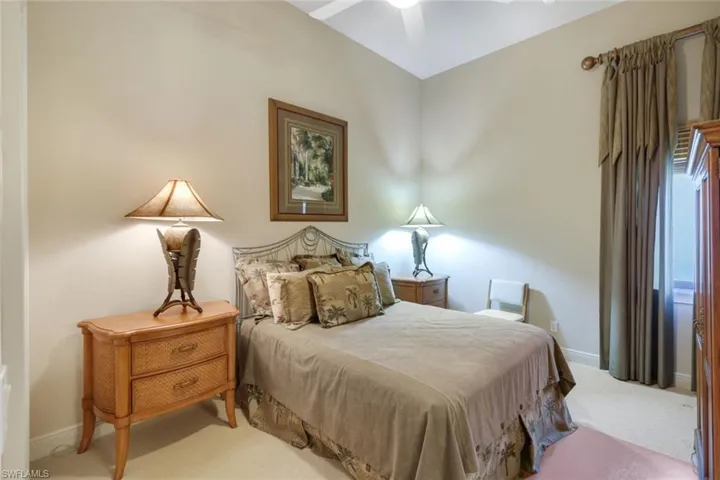 Carpeted bedroom featuring ceiling fan