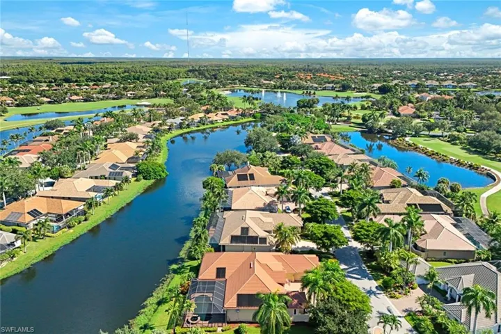 Birds eye view of property with a water view