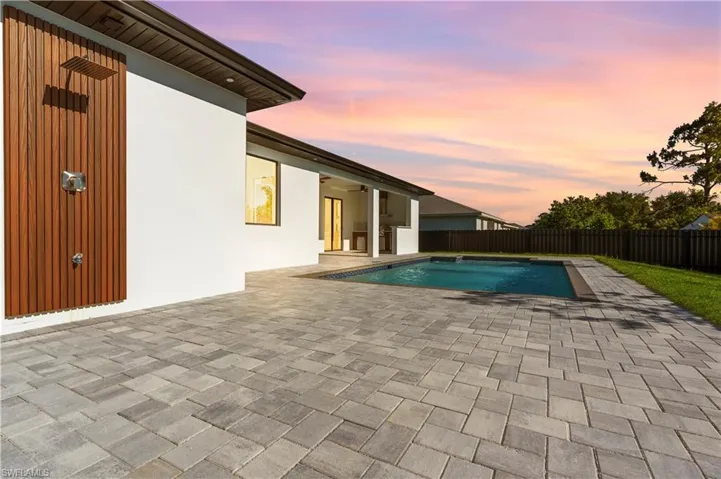 View of swimming pool with a patio area, a fenced backyard, a fenced in pool, and a ceiling fan
