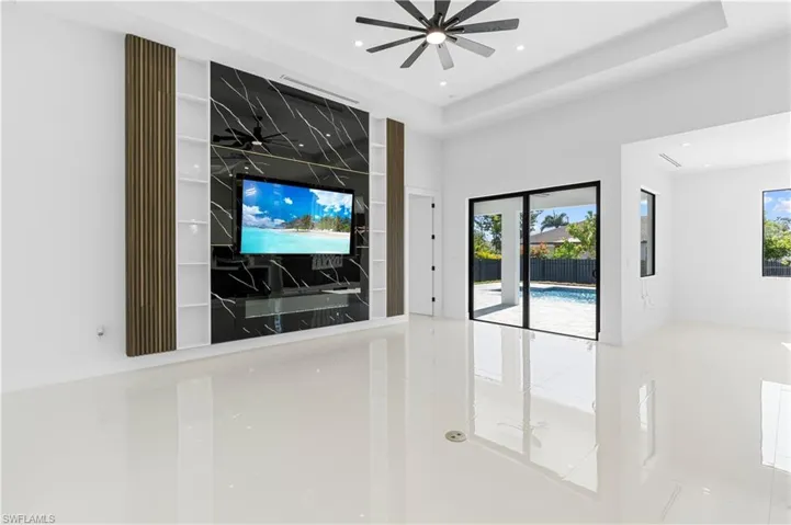 Unfurnished living room with recessed lighting, ceiling fan, and a healthy amount of sunlight