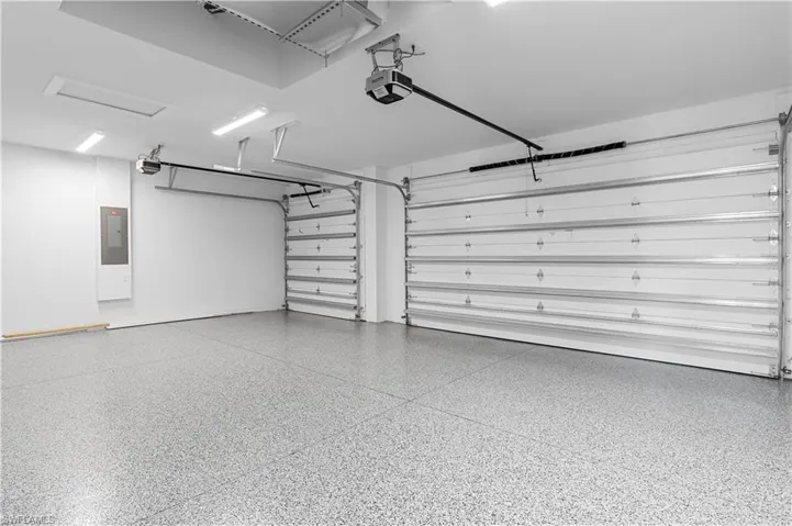 Garage with electric panel and a garage door opener