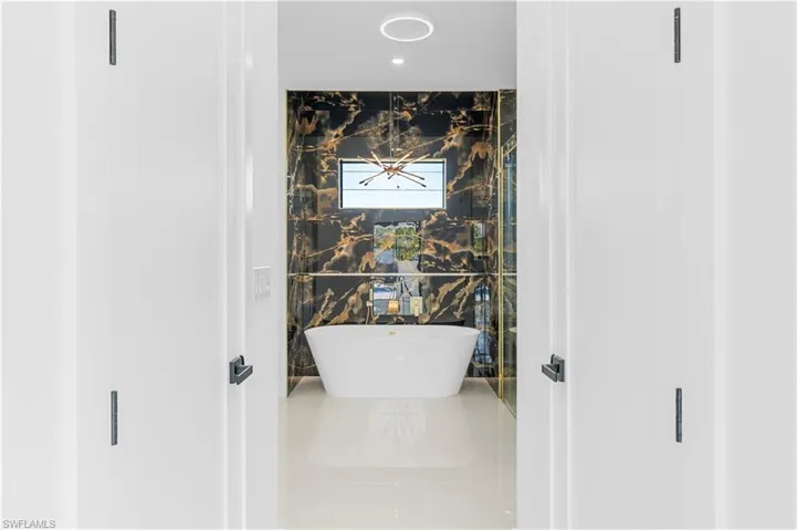 Full bath with recessed lighting and a soaking tub