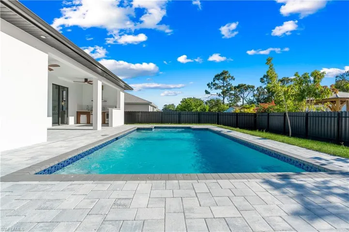 View of swimming pool featuring a ceiling fan, a fenced in pool, a fenced backyard, and a patio