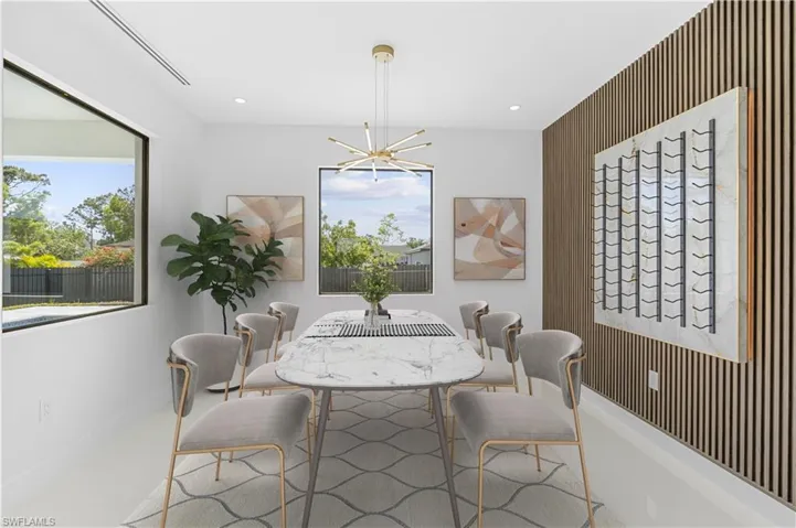 Dining room featuring a chandelier, recessed lighting, and baseboards
