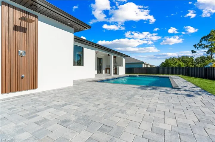 View of swimming pool featuring ceiling fan, a fenced backyard, a fenced in pool, and a patio