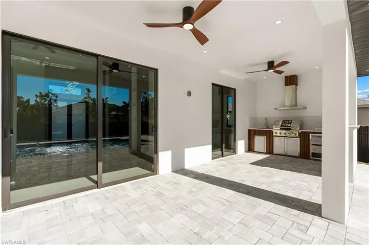 View of patio / terrace featuring grilling area, a ceiling fan, a sink, and area for grilling