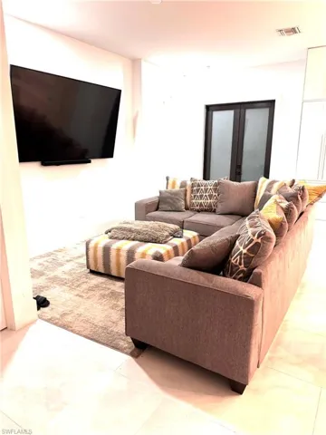 Living area featuring marble finish floors