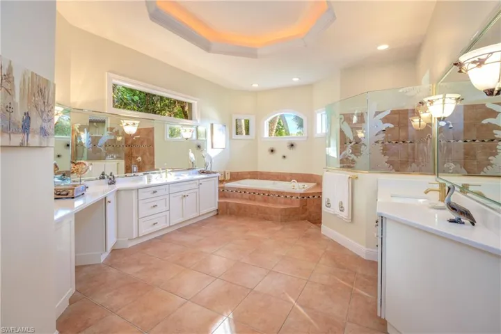 Primary bathroom is huge with separate dual vanities.  His & her closet area flows between this ensuite and the primary bedroom