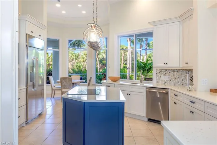Kitchen is open and airy and looks out onto the natural preserve