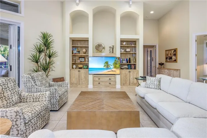 Living room features custom built in shelving