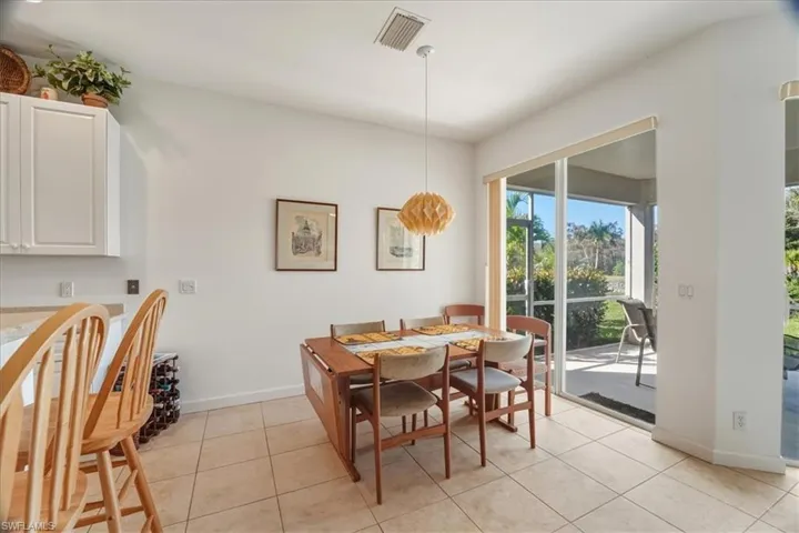 Dining space with light tile patterned floors and baseboards
