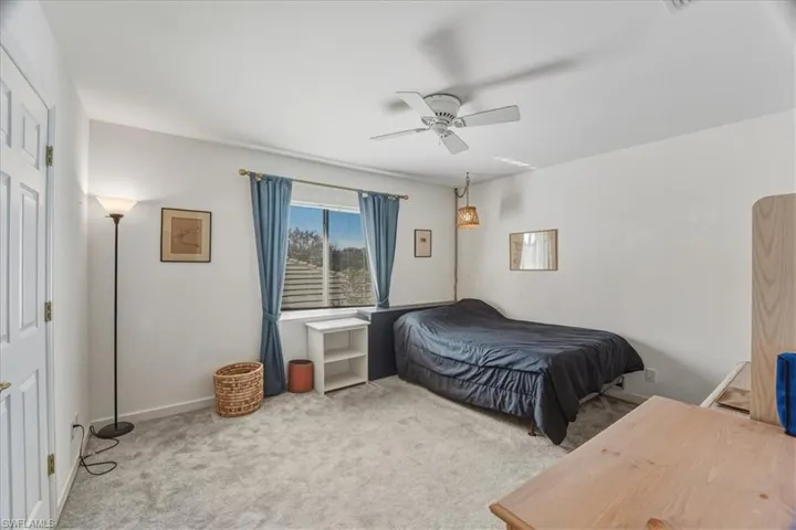 Bedroom with carpet floors and a ceiling fan