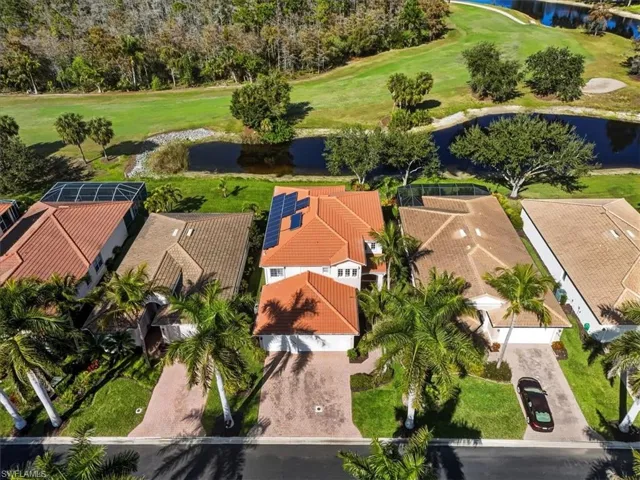 Aerial view of residential area with a large body of water and a golf course