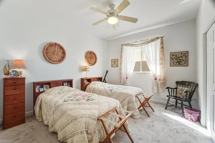 Bedroom with carpet floors, ceiling fan, and a closet