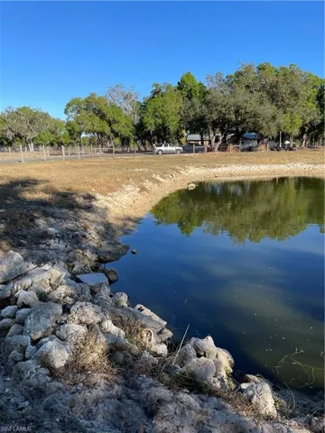 Natural water feature with rocky shoreline and mature trees