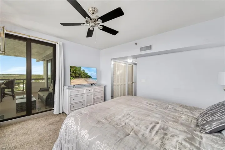 Master bedroom featuring lanai access and more views.