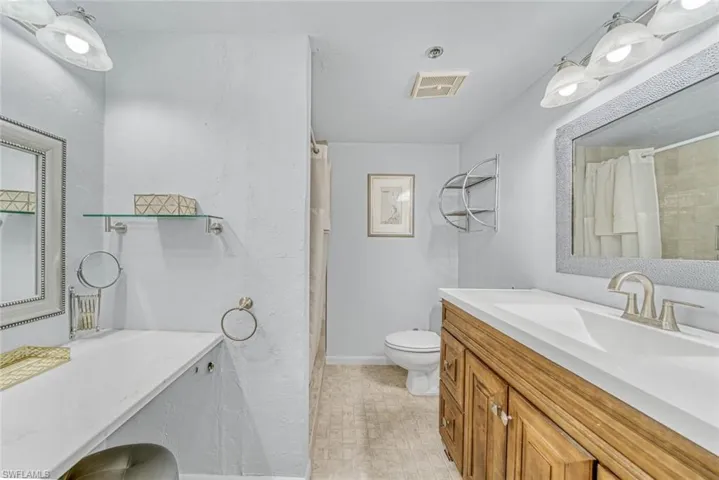 Master bathroom with lighted makeup vanity and walk in shower.