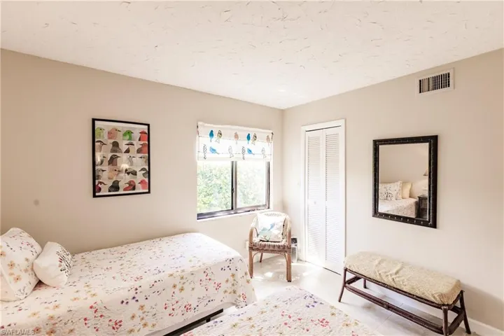Bedroom featuring a closet and a textured ceiling