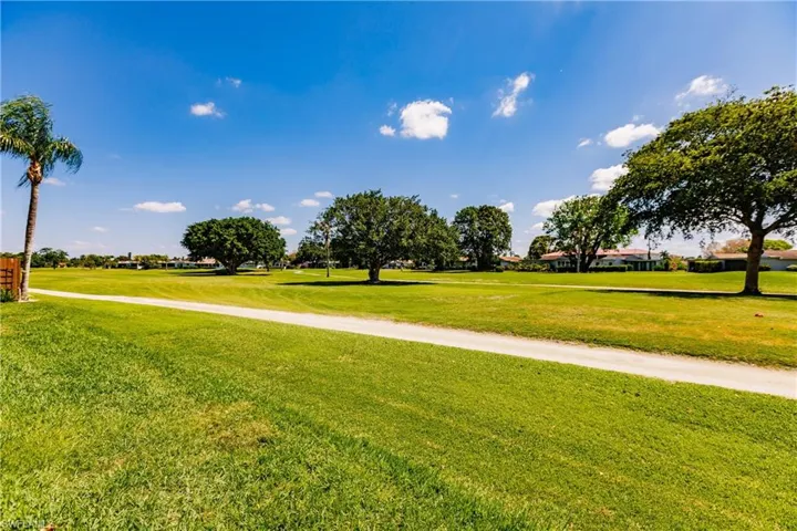 View of property's community with a yard