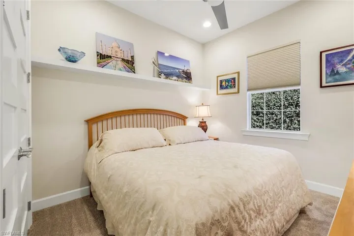 Carpeted bedroom featuring a ceiling fan and recessed lighting