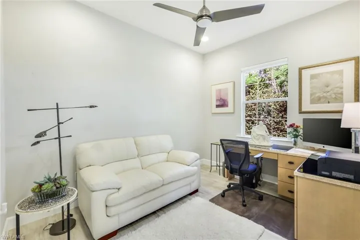 Office space with wood finished floors, ceiling fan, and recessed lighting