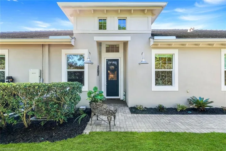 Entrance to property featuring stucco siding