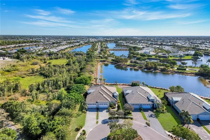 Aerial perspective of suburban area featuring a large body of water
