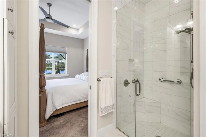 Ensuite bathroom featuring a stall shower, carpet, ceiling fan, and recessed lighting