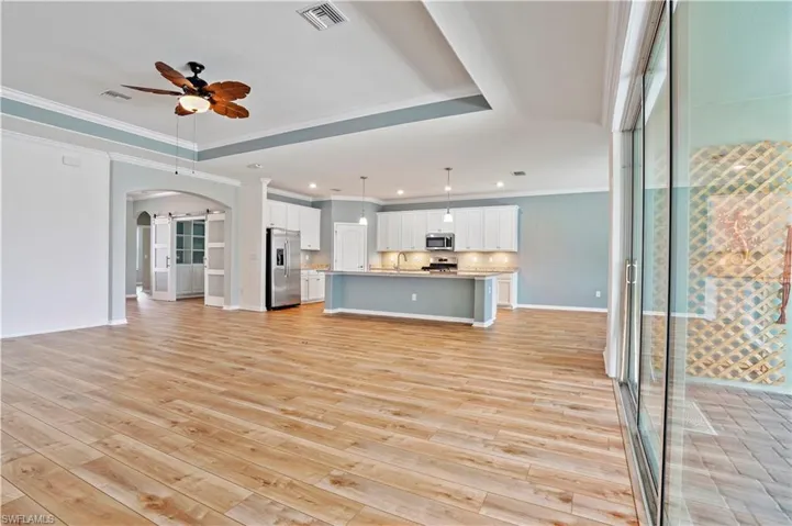 Expansive room with tray ceiling and crown molding