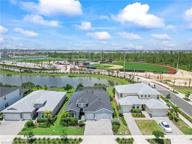 Birds eye view of property with a water view