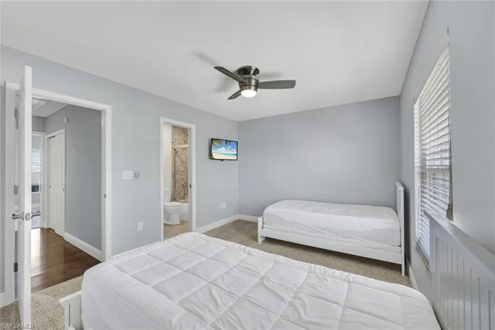 Room featuring light gray walls and neutral carpet flooring