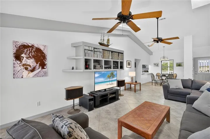 Living area vaulted ceiling, and light tile patterned flooring